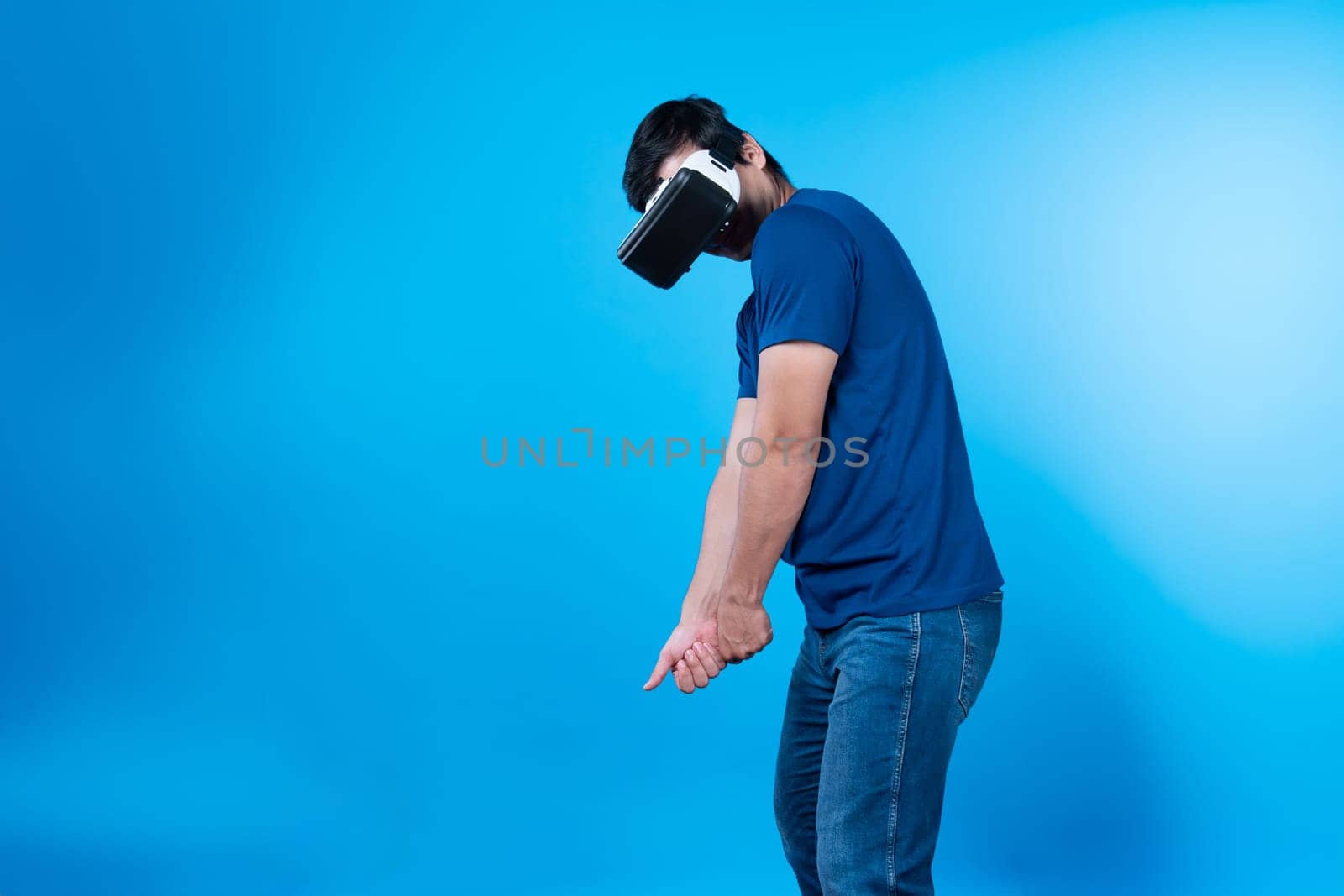 Smart gaming player wearing VR glasses playing golf distance course hologram isolated blue background screen connecting digital futuristic technology virtual reality in metaverse world. Contrivance.