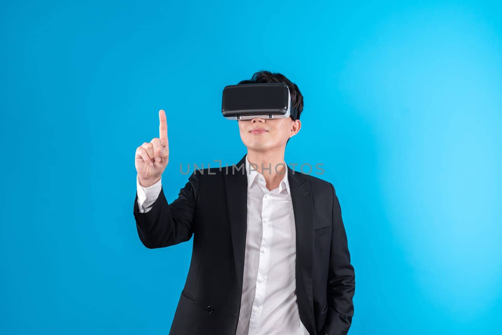 Asian businessman looking thorough VR while touching screen with connecting business world report in futuristic metaverse analyzing innovation technology virtual reality blue copyspace. Contrivance.