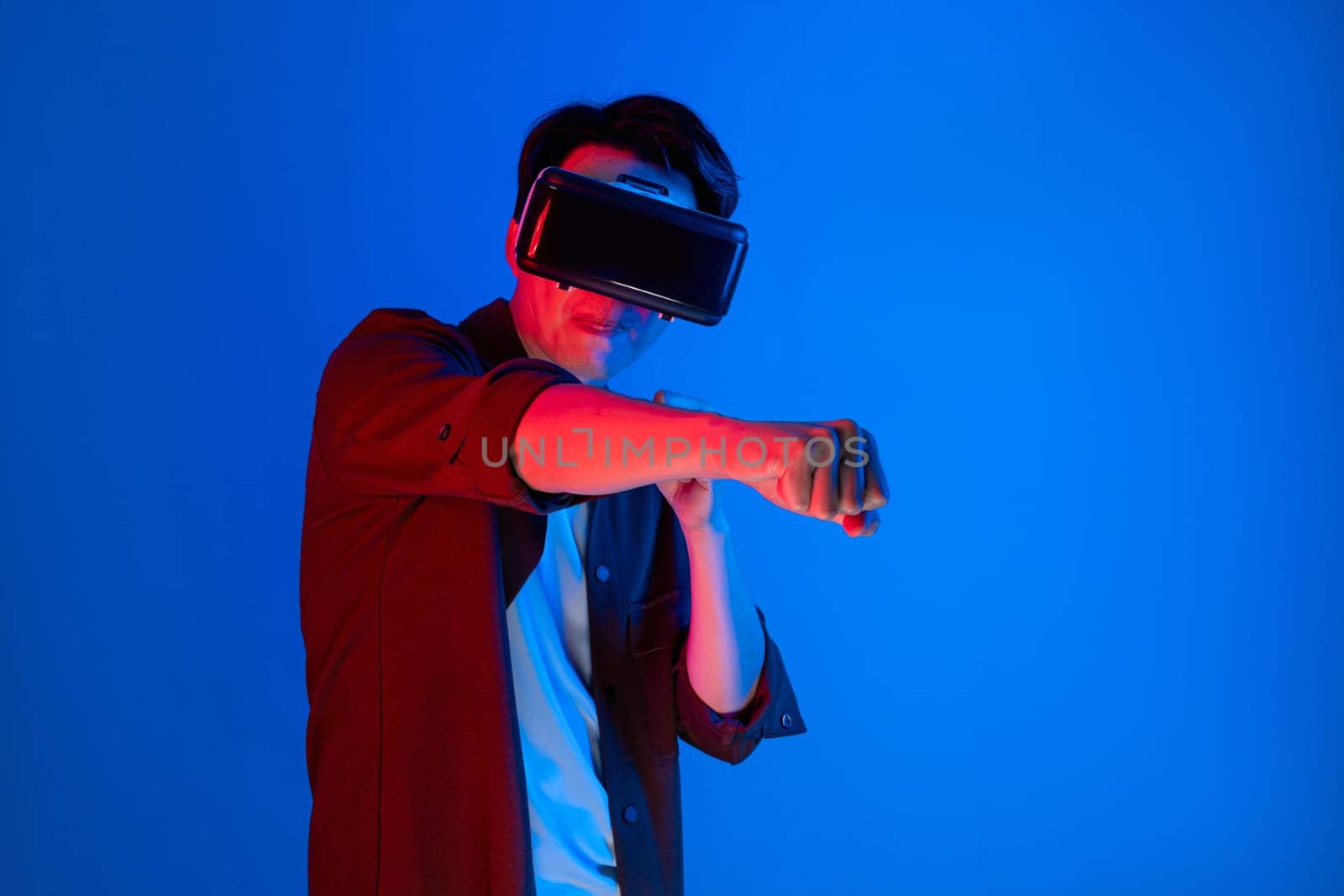 Boxing gamer wearing VR boxer game isolated blue neon light wall. Contrivance. by biancoblue