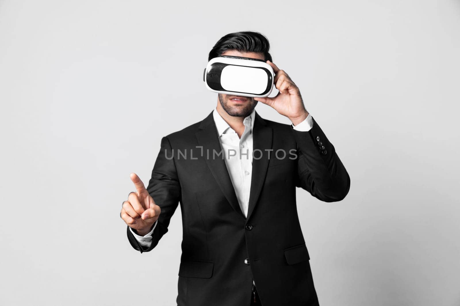 Project manager with virtual reality glasses looking at data analysis while analyzing and pointing data. Skilled business man using VR goggle and digital innovation while enter metaverse. Deviation.