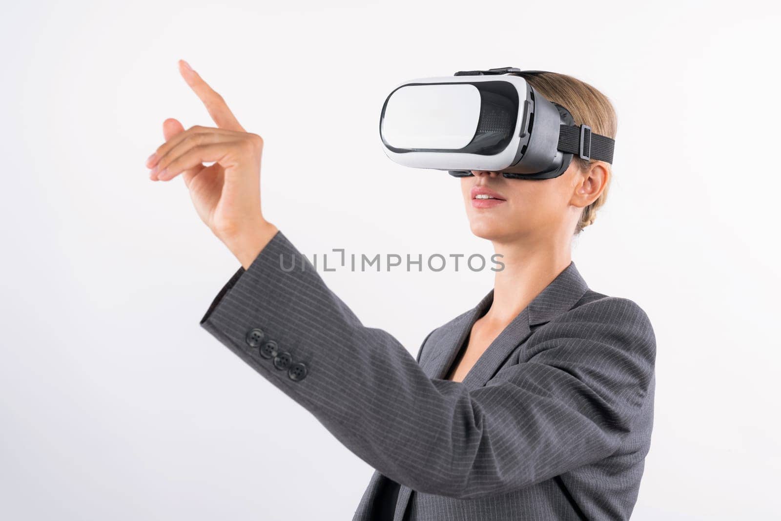 Professional female leader touching at program or working while using VR glasses. Skilled businesswoman pointing at system while connecting at metaverse by wearing visual reality goggles. Contraption.