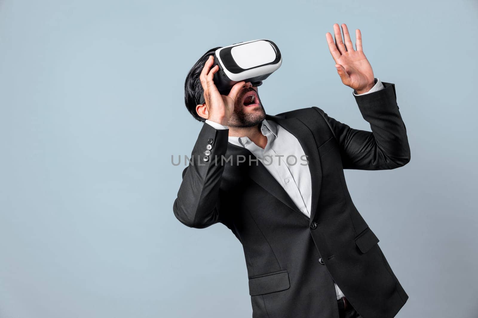 Close up of smart project manager looking financial graph hologram from VR glass. Professional business man surprised while checking financial plan from virtual reality world and metaworld. Deviation.