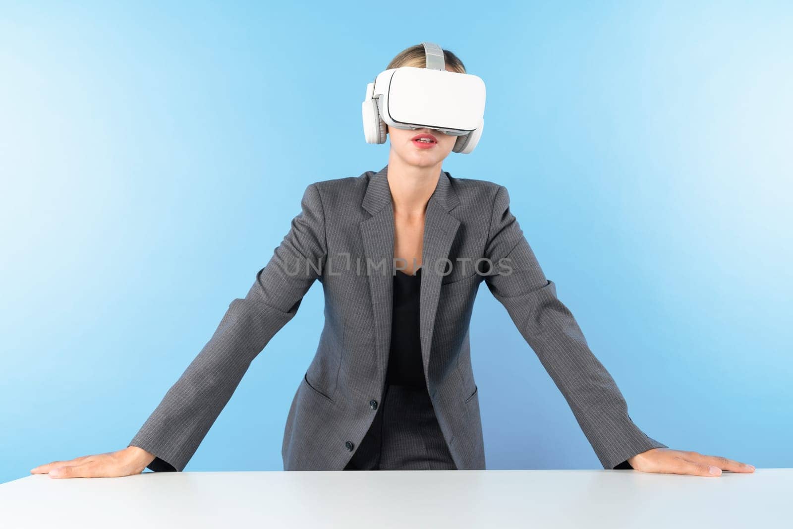 Project manager wearing VR headset and standing while holding innovation technology hologram. Skilled businesswoman connect with visual reality world while looking at data for investment. Contraption.