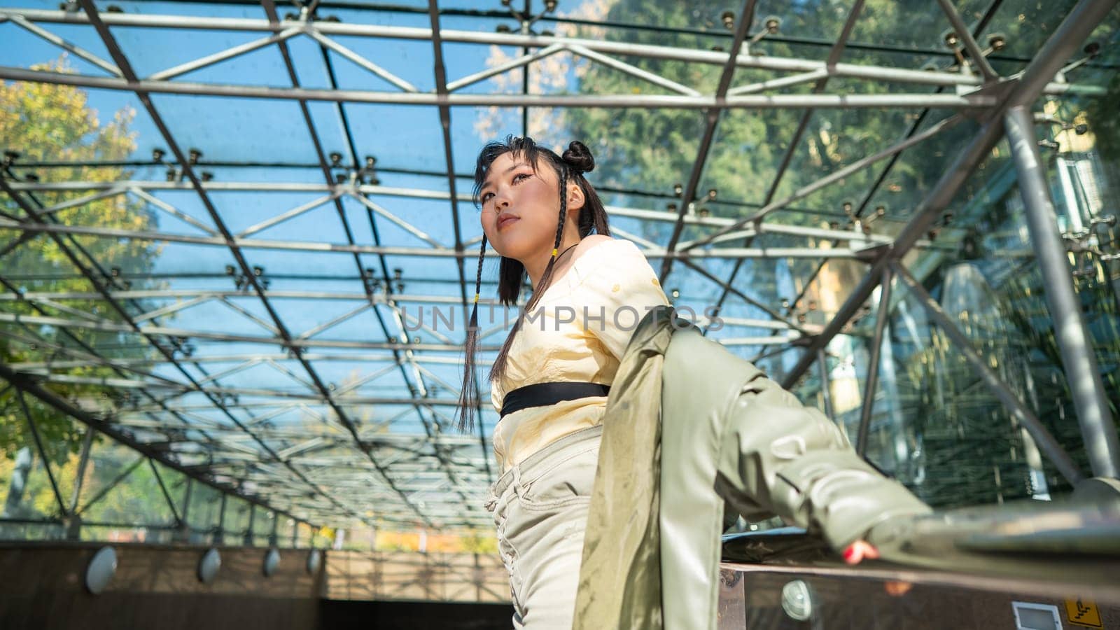 Young Asian woman posing at subway exit