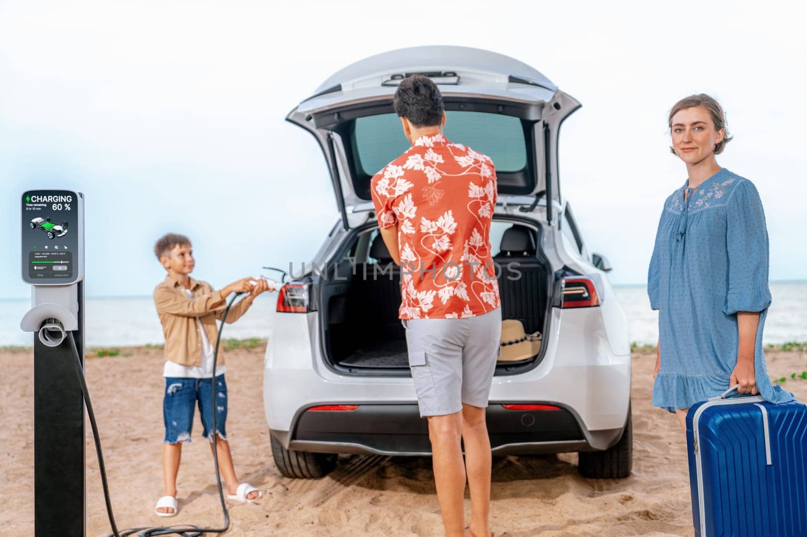 Family vacation trip traveling by the beach with electric car, lovely family taking luggage out while charging EV car battery with clean energy. Alternative family travel by eco-friendly car.Perpetual