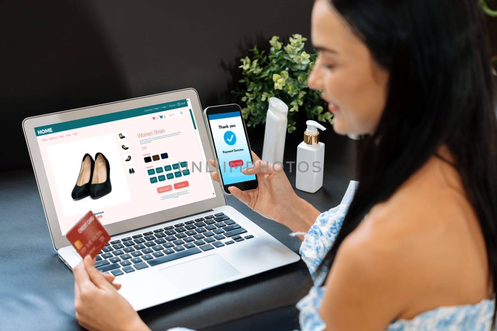 Young woman order or purchase product on internet using laptop and make transaction payment by smartphone. Online shopping lifestyle with credit card via internet banking on mobile application. Blithe