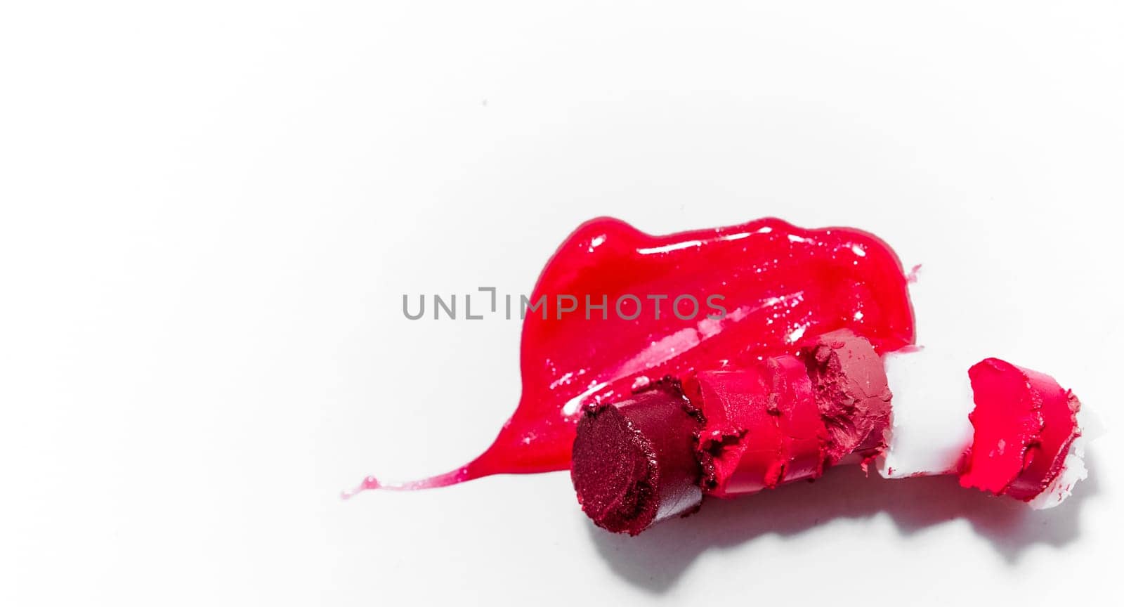 Beauty texture, cosmetic product and art of make-up concept - Cutted and liquid lipstick close-up isolated on white background