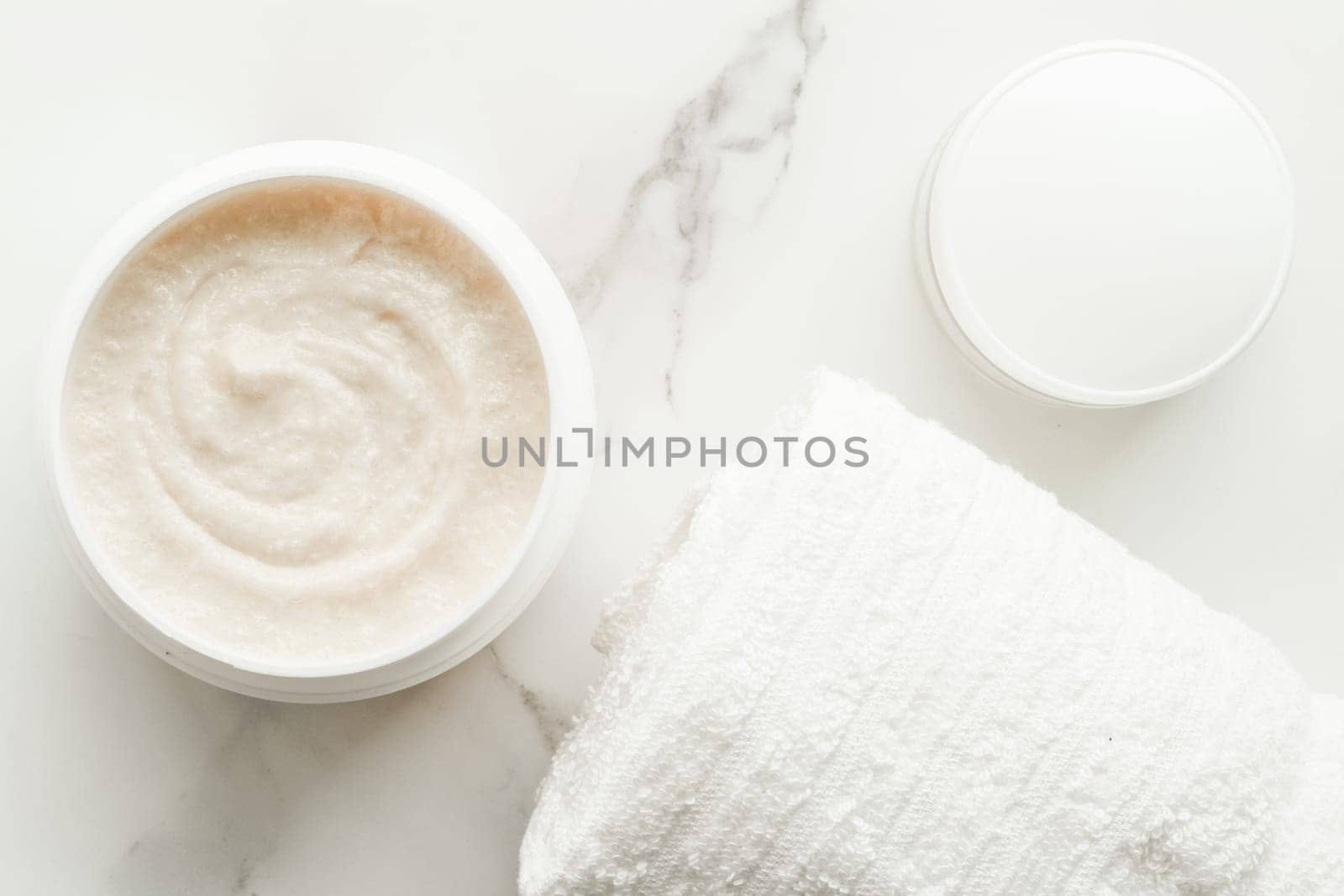 Scrub and exfoliating cream products on a marble, flatlay - skincare and body care, luxury spa and clean cosmetic concept. Health and beauty of your skin
