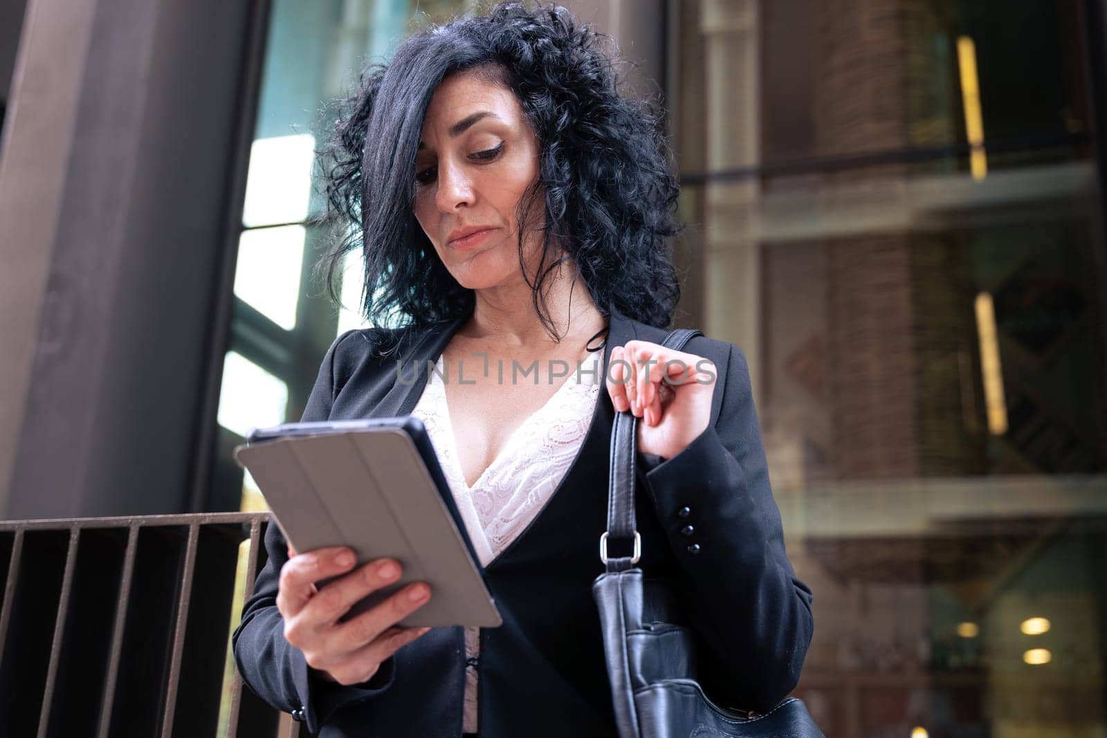 Caucasian businesswoman with digital tablet outdoors. by molesjuny