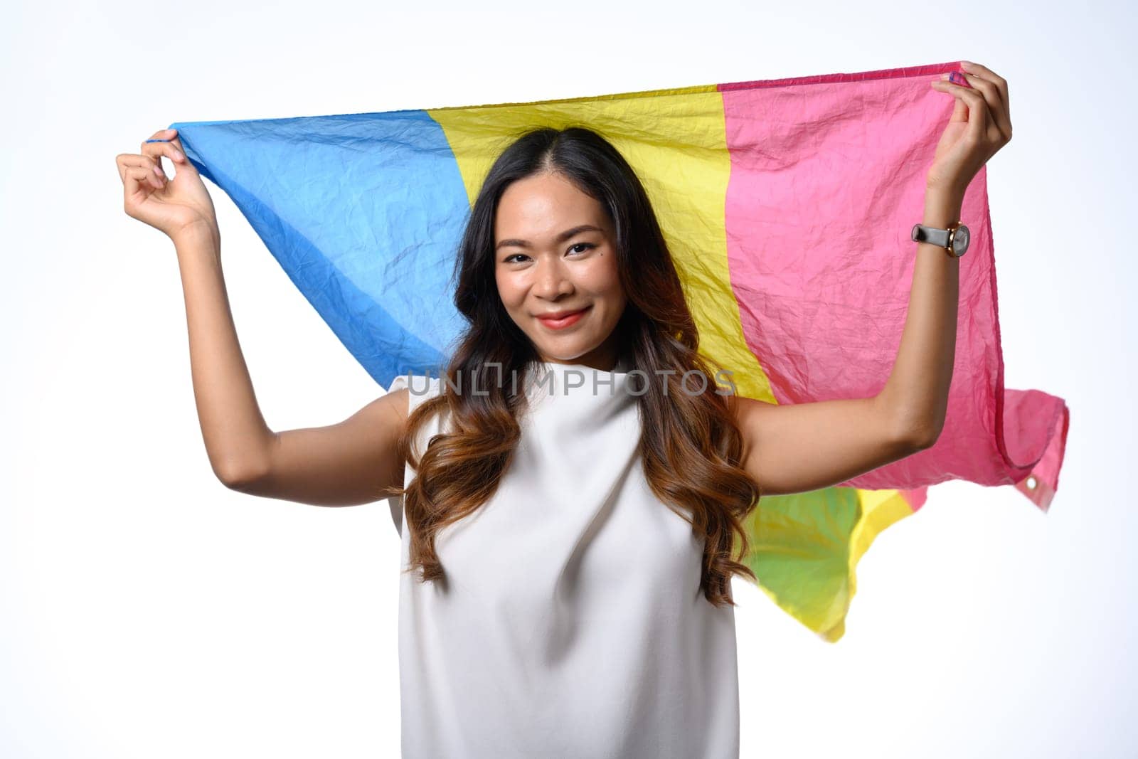 Confident young adult woman holding pansexual flag isolate white background. Lgbtq, human rights and equality concept by prathanchorruangsak