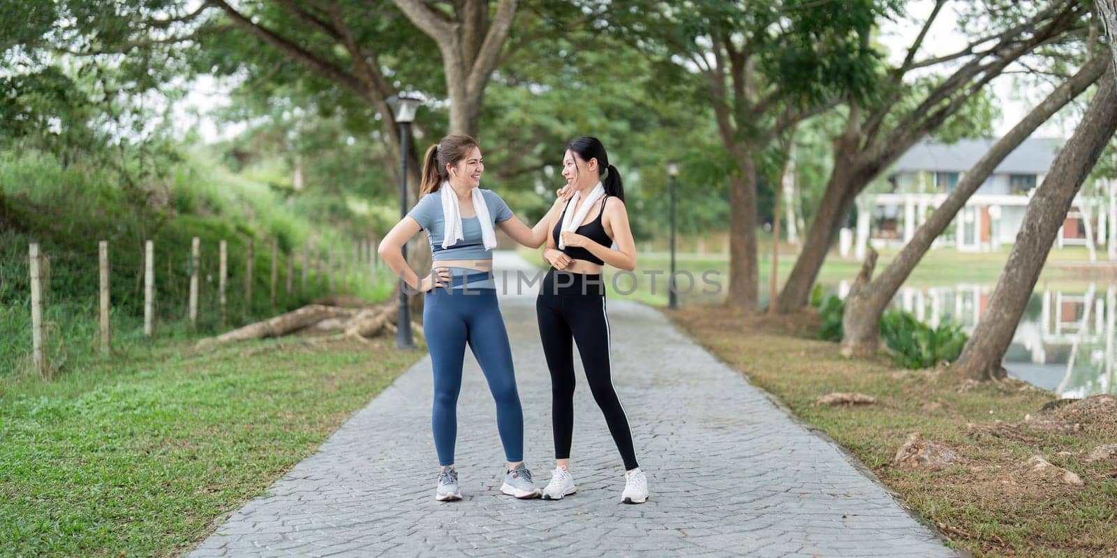 Two Friends Enjoying a Morning Run Together in a Scenic Park Setting, Promoting Fitness and Healthy Lifestyle by nateemee