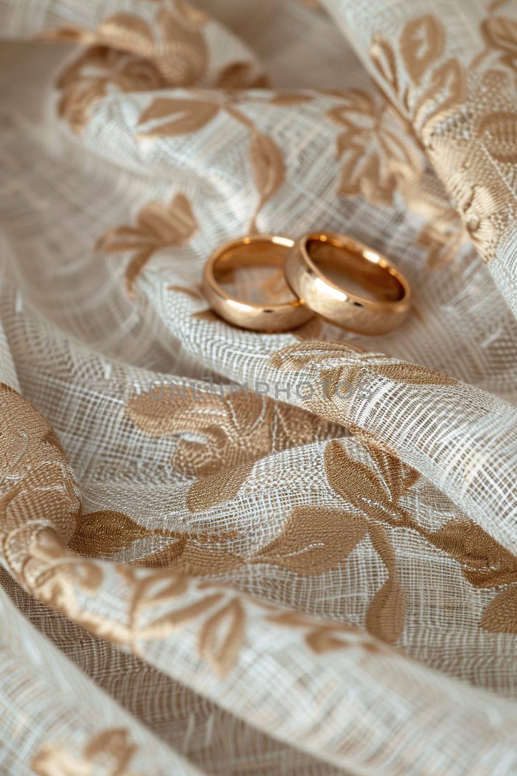 Elegant wedding background displaying two golden rings nestled on a textured fabric with delicate floral embroidery, offering a romantic ambiance and ample copy space for customization. Generative AI