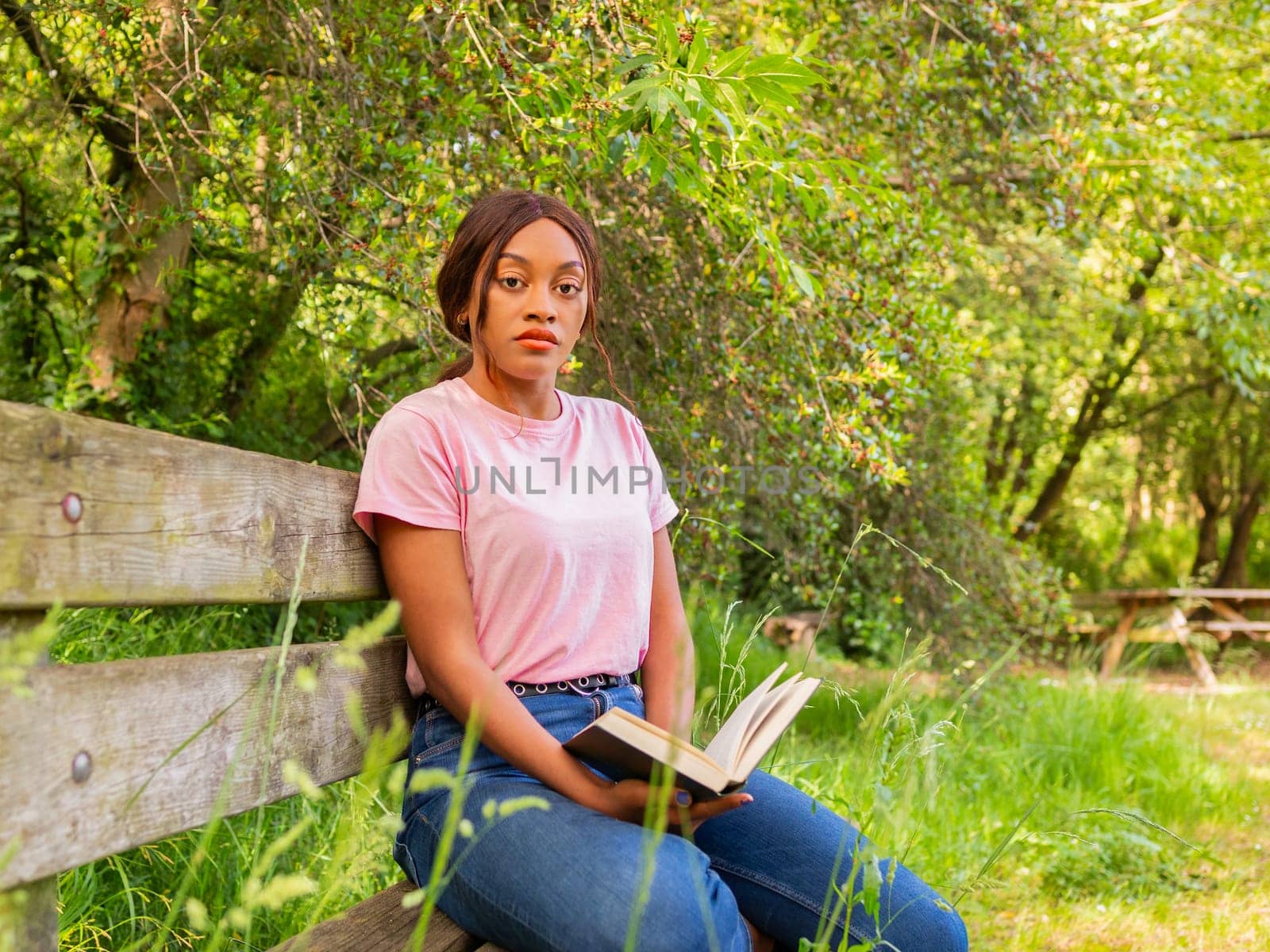 Woman Sitting on Bench Reading a Book by Ceballos