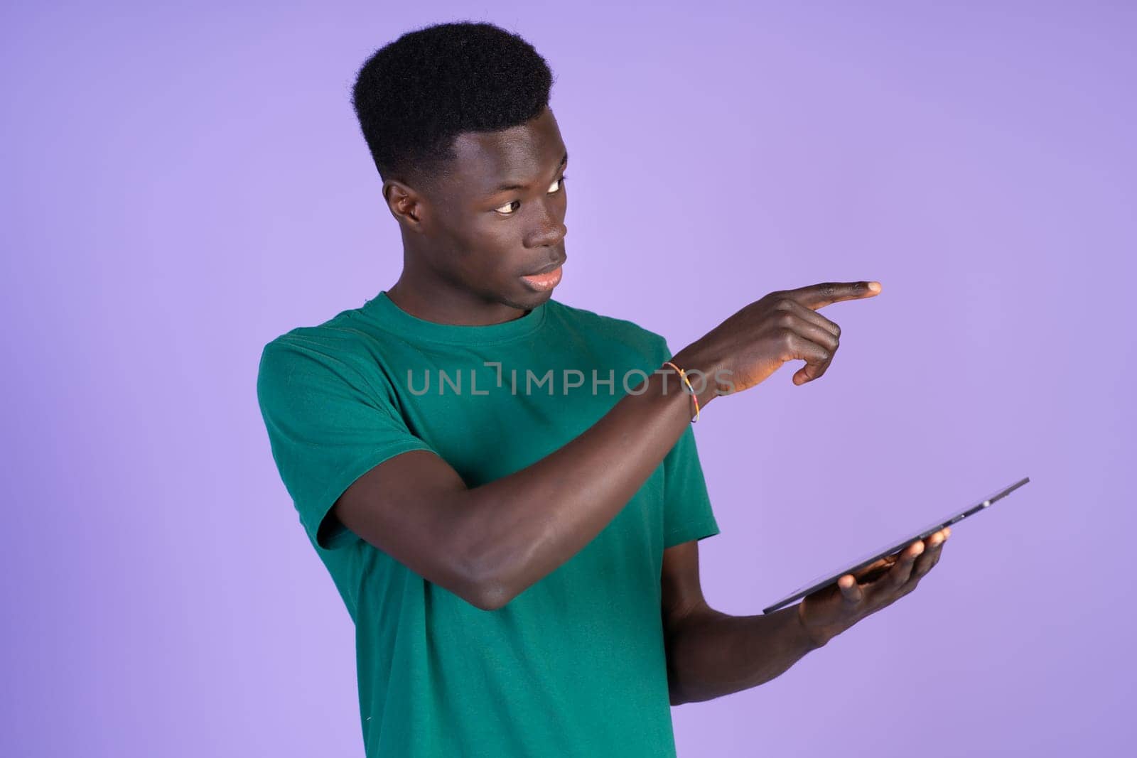 Man in Green Shirt Holding Tablet by Ceballos