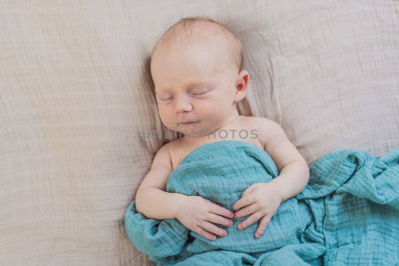 The baby is sleeping peacefully in his cozy nest. Newborn photo session captures the serene innocence and warmth of early moments.