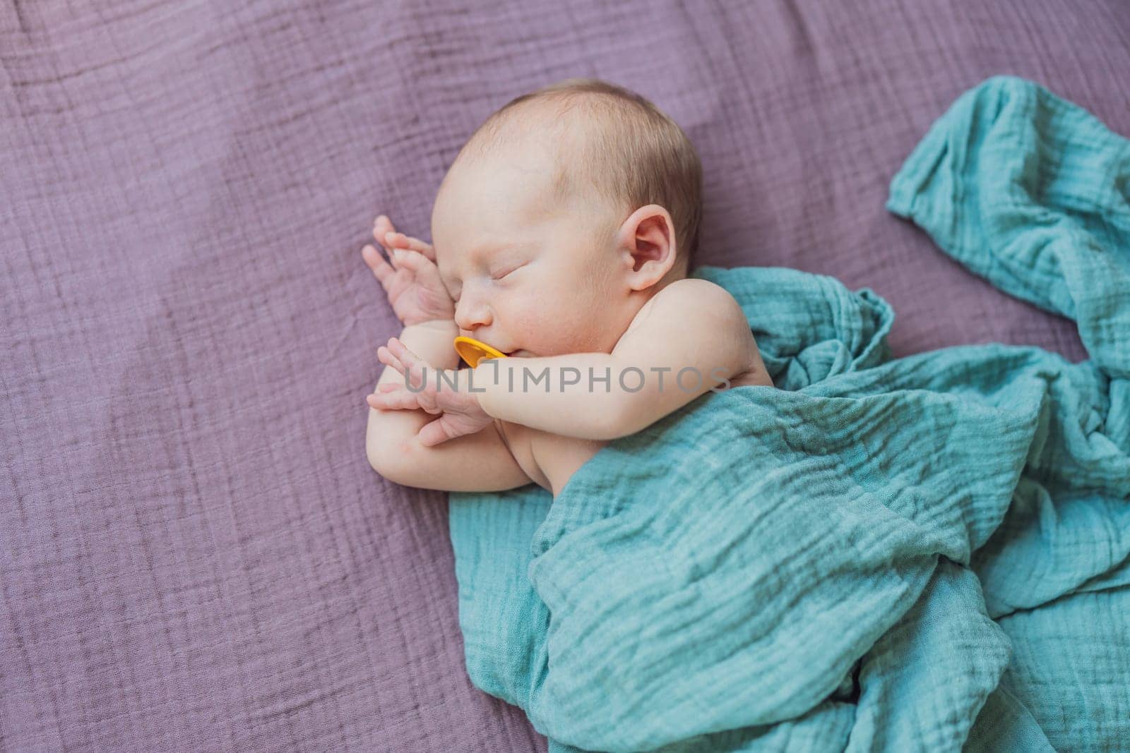 The baby is sleeping peacefully in his cozy nest. Newborn photo session captures the serene innocence and warmth of early moments.