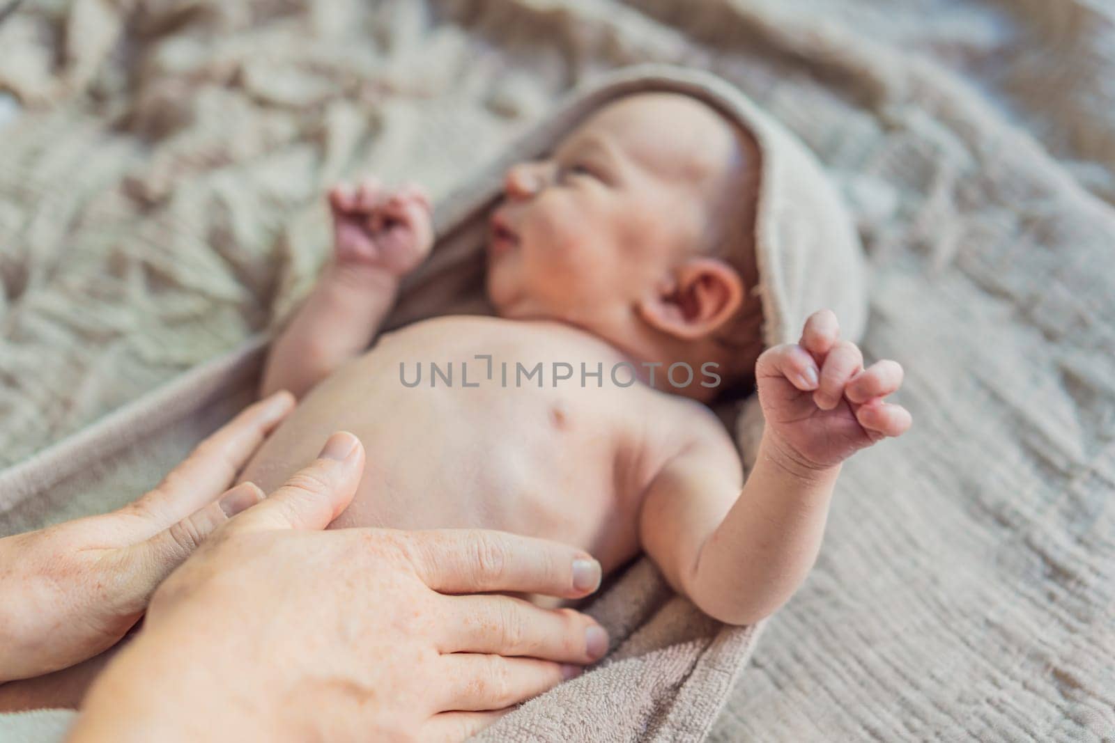 The newborn's skin is peeling. Mom uses skin products and massages to care for and soothe the baby's delicate skin, ensuring comfort and promoting healthy skin.