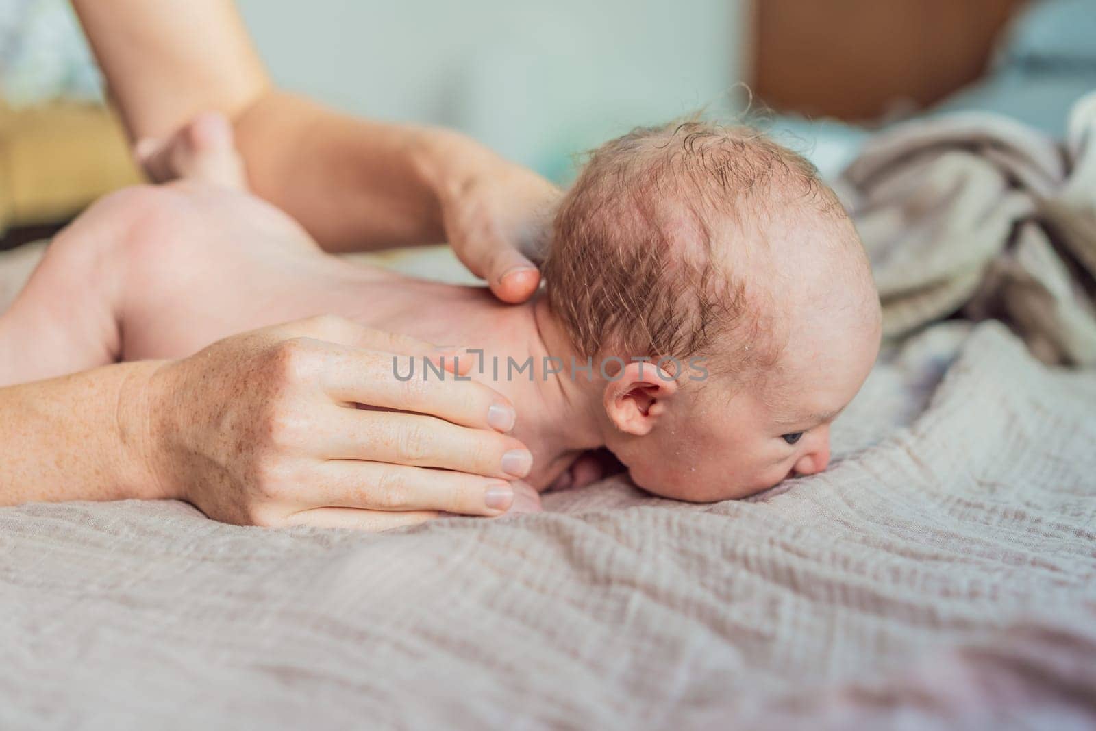 The newborn's skin is peeling. Mom uses skin products and massages to care for and soothe the baby's delicate skin, ensuring comfort and promoting healthy skin.