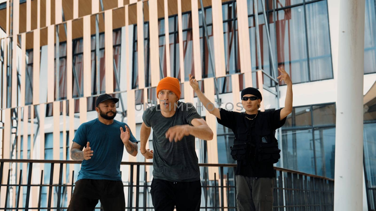 Hip hop team dance break dance while multicultural friend surrounded and clapping hands to cheer or encourage his friend to dance. Active and energetic street dance. Outdoor sport 2024. Endeavor.