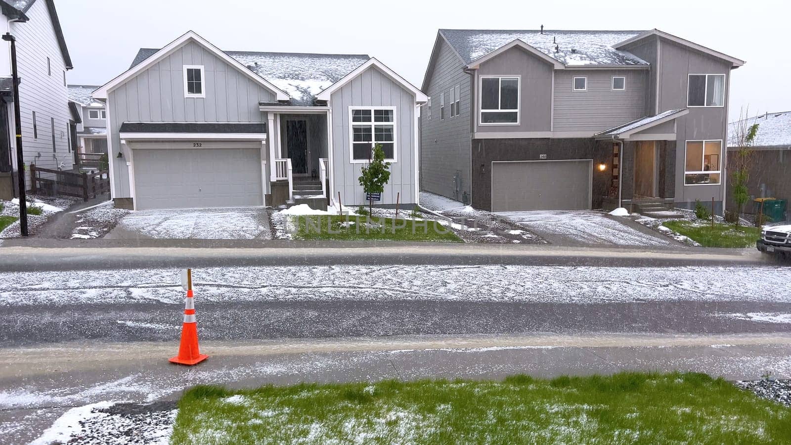 Suburban Neighborhood Covered in Hail After a Storm by arinahabich