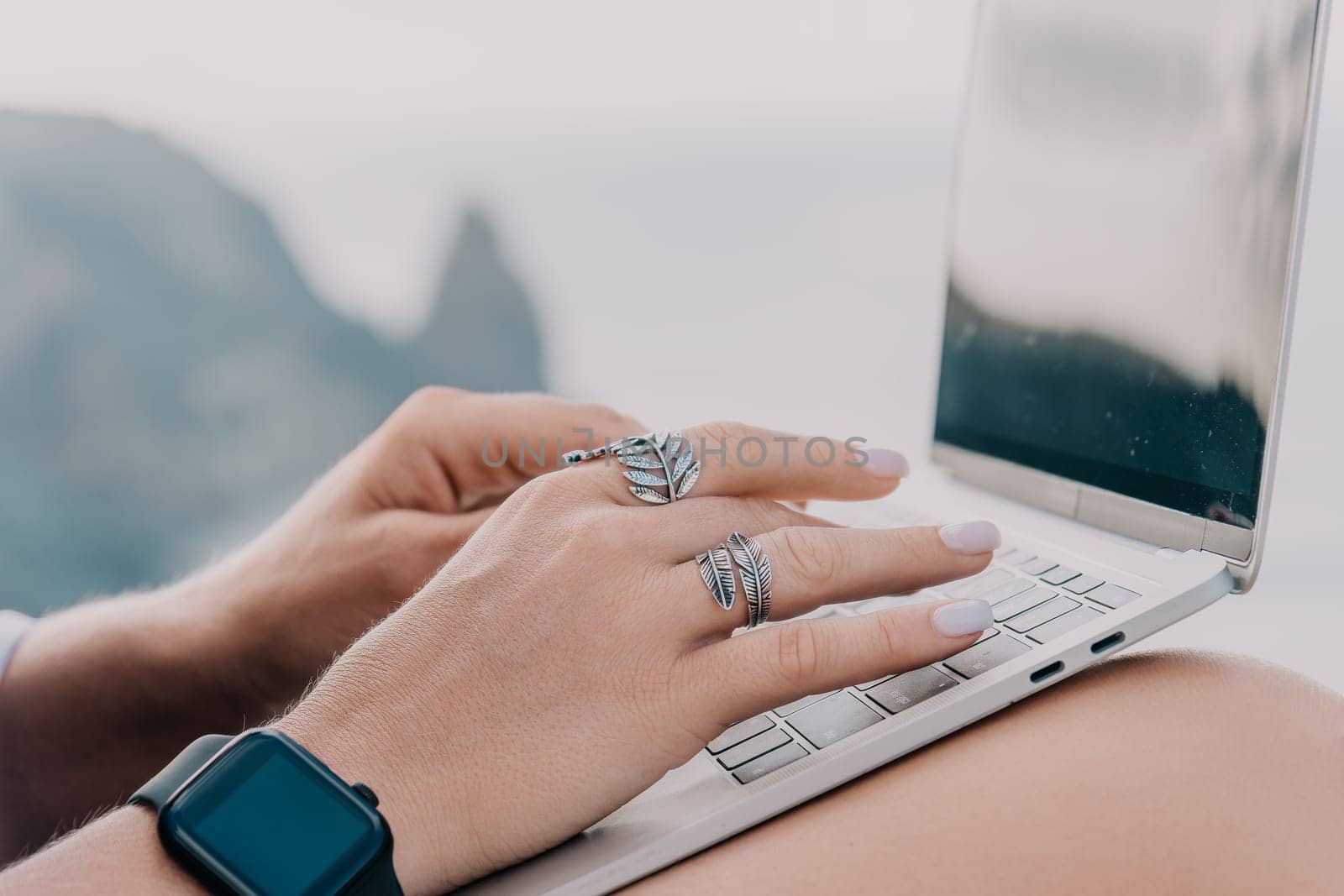 Woman sea laptop. Business woman, freelancer with laptop working over blue sea beach. Happy smiling girl relieves stress from work. Freelance, remote work on vacation, digital nomad, travel concept by panophotograph