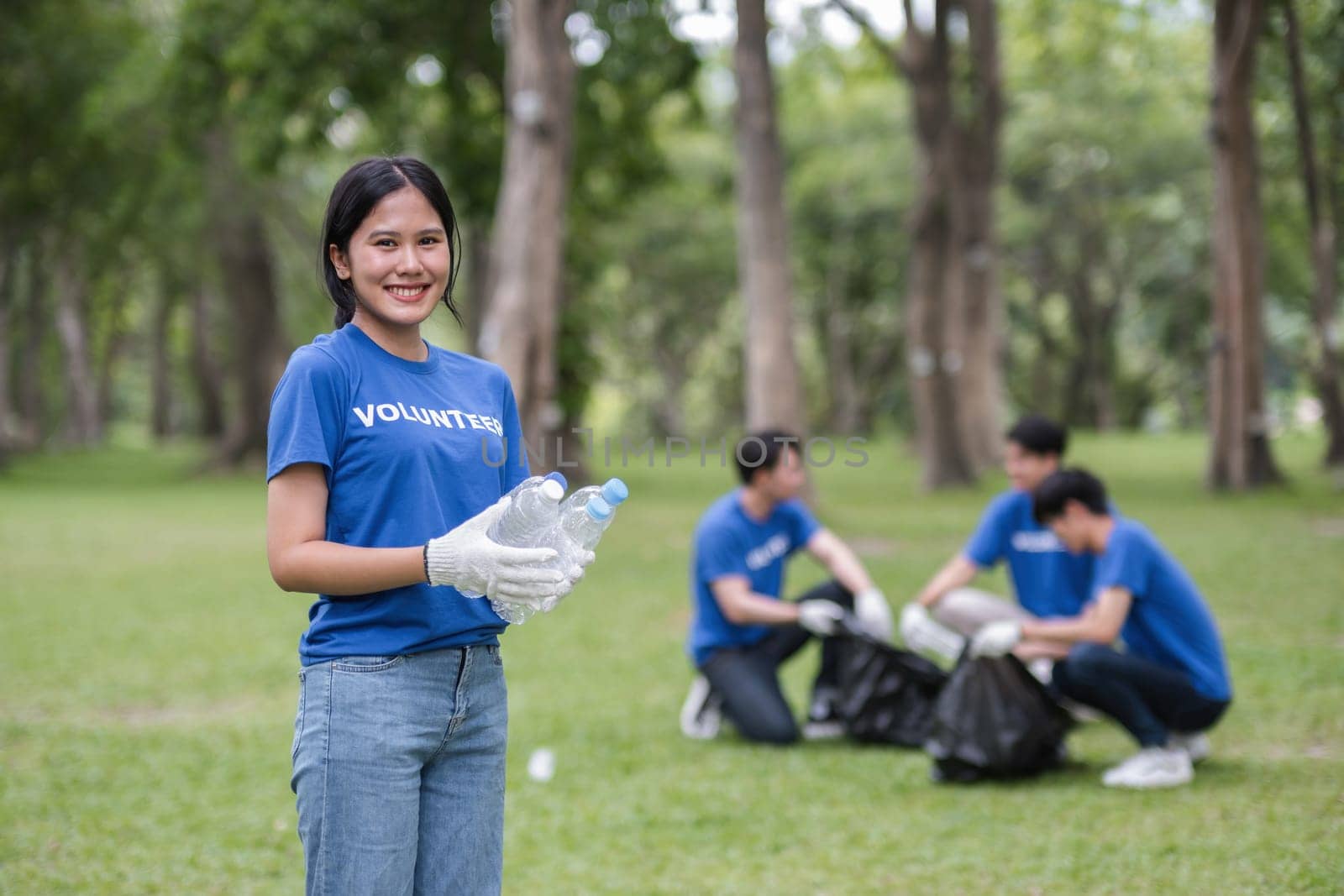 A dedicated volunteer team picks up trash in a park, showcasing community effort and environmental stewardship.