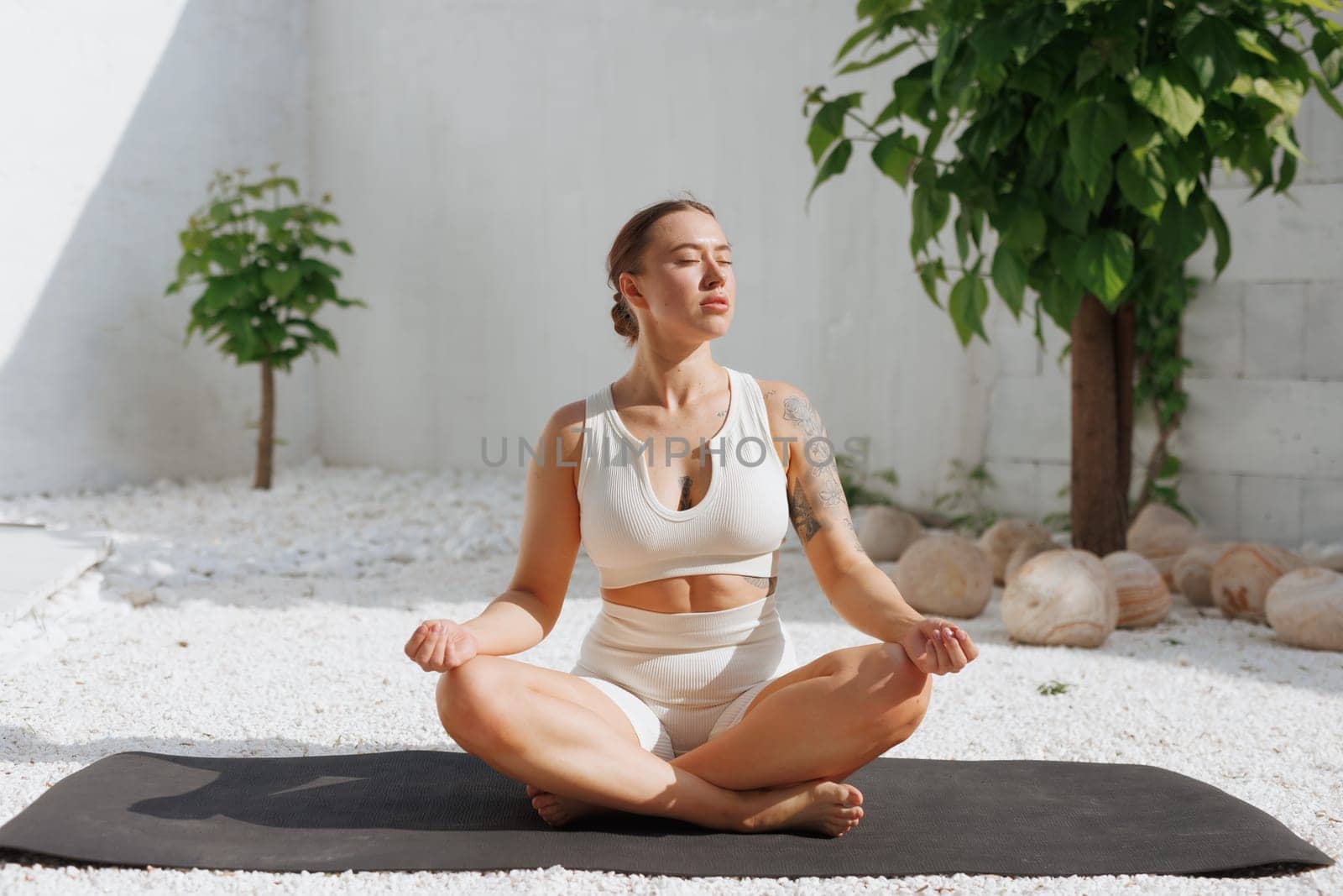 yoga stretching outdoors. side view of overweight woman practicing yoga on white background, body care concept, fighting excess weight losing weight