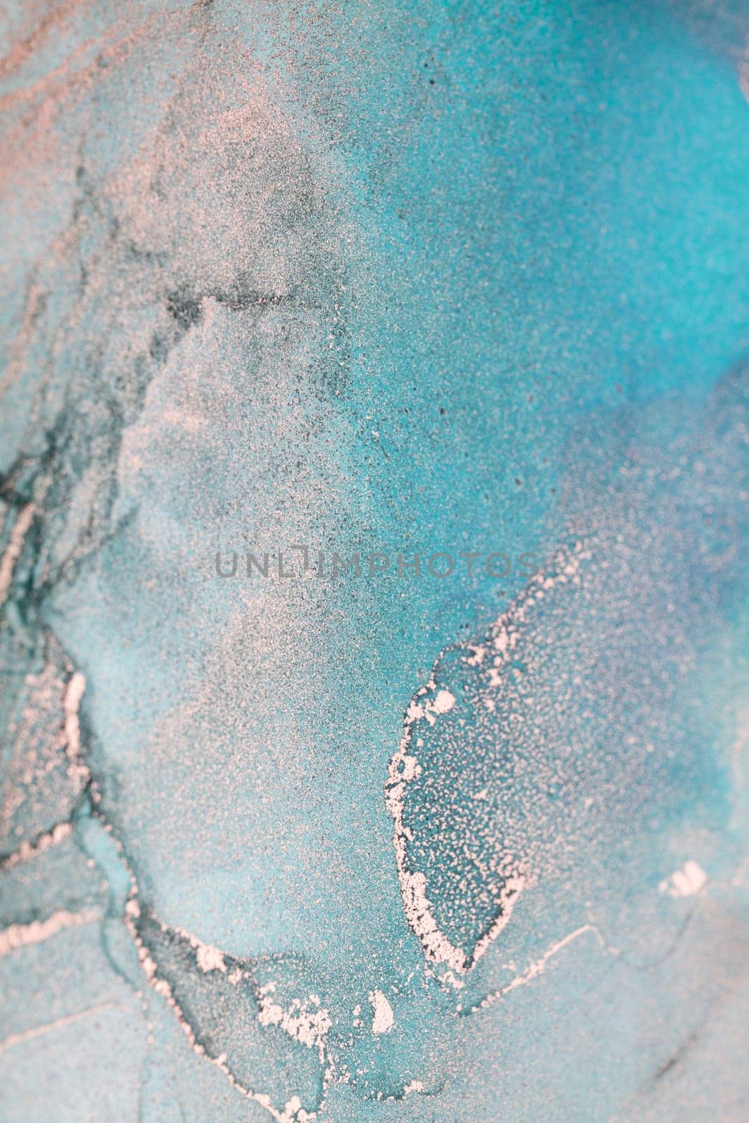 A close-up abstract image of swirling teal and aqua paint with shimmering gold accents.