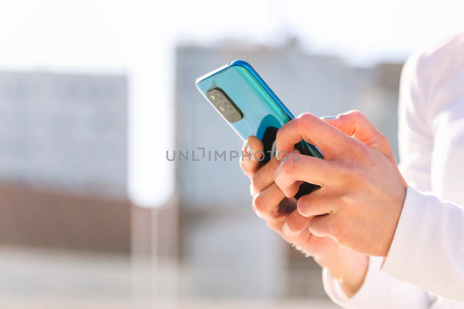 close up of the hands of a person using mobile phone, concept of technology of communication and social media, copy space for text