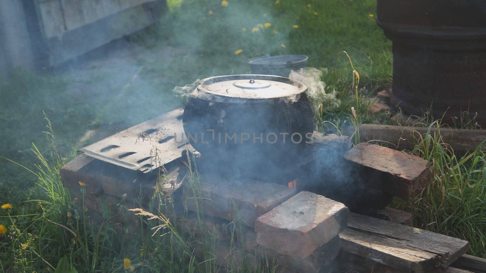 The cast iron in the village is used to cook food for the livestock. by DovidPro
