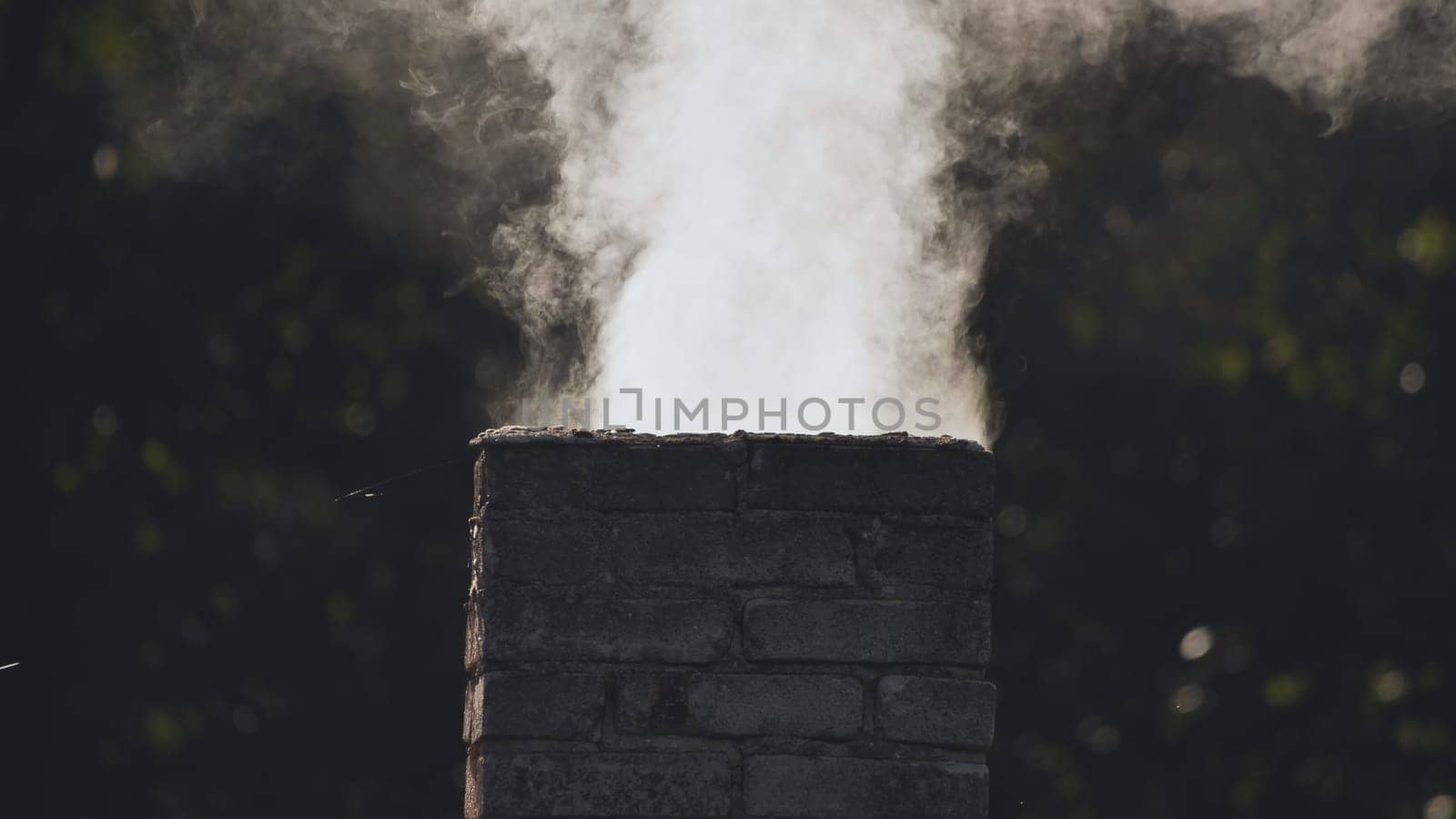 White smoke from the chimney of the village house. by DovidPro