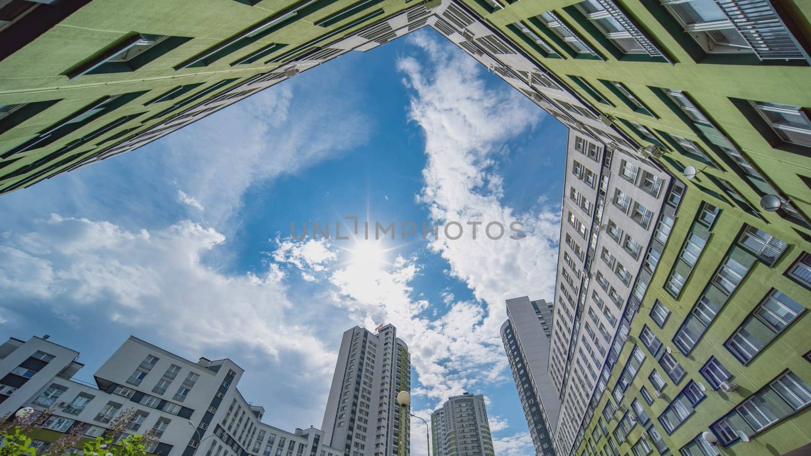 A timelapse of clouds in the background of an apartment complex