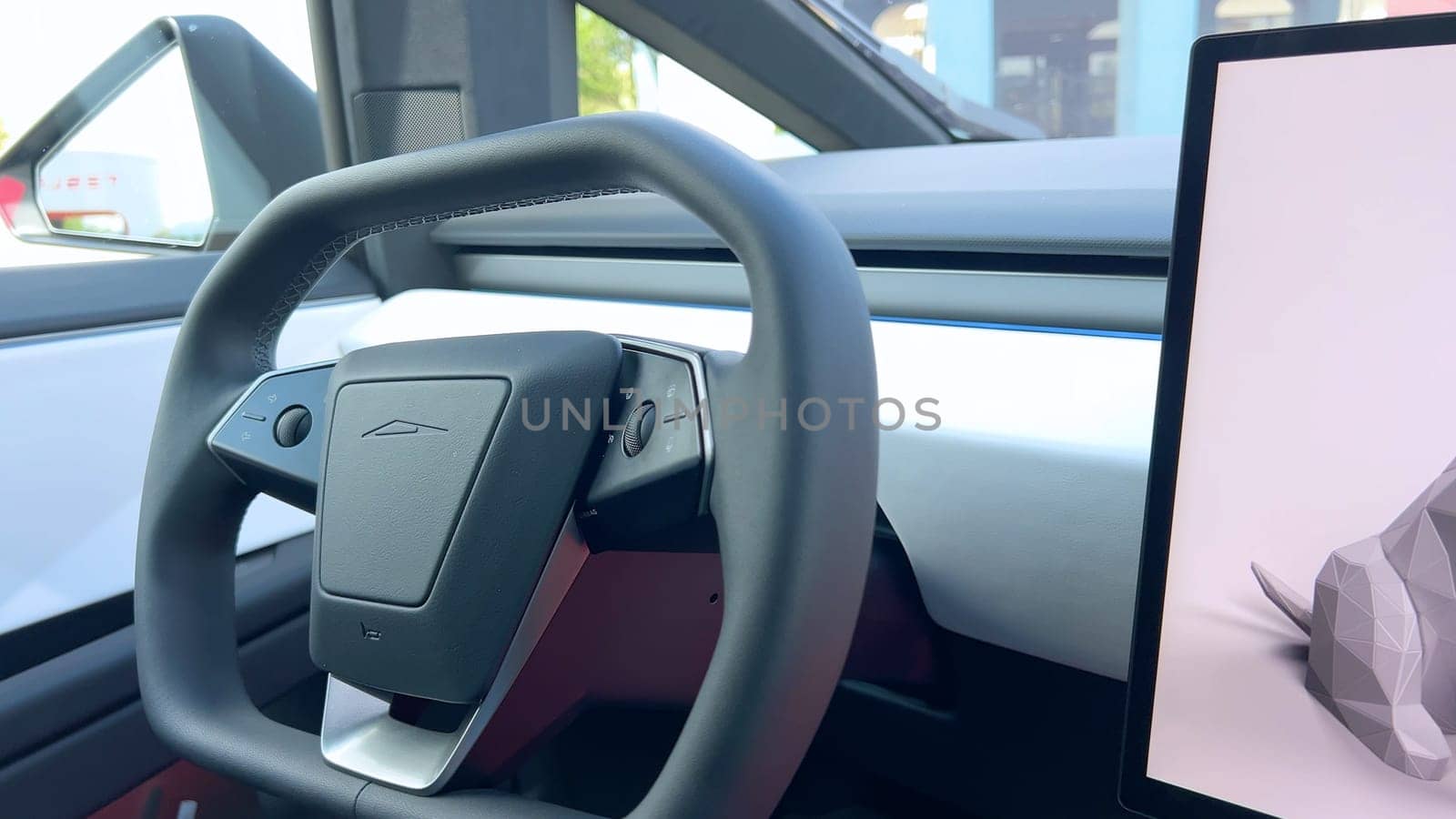 Denver, Colorado, USA-June 11, 2024-Slow motion-The interior of a Tesla car featuring the Dog Mode screen. The display reassures passersby that the driver will be back soon and the air conditioning is set to 69F for the comfort of a pet inside.