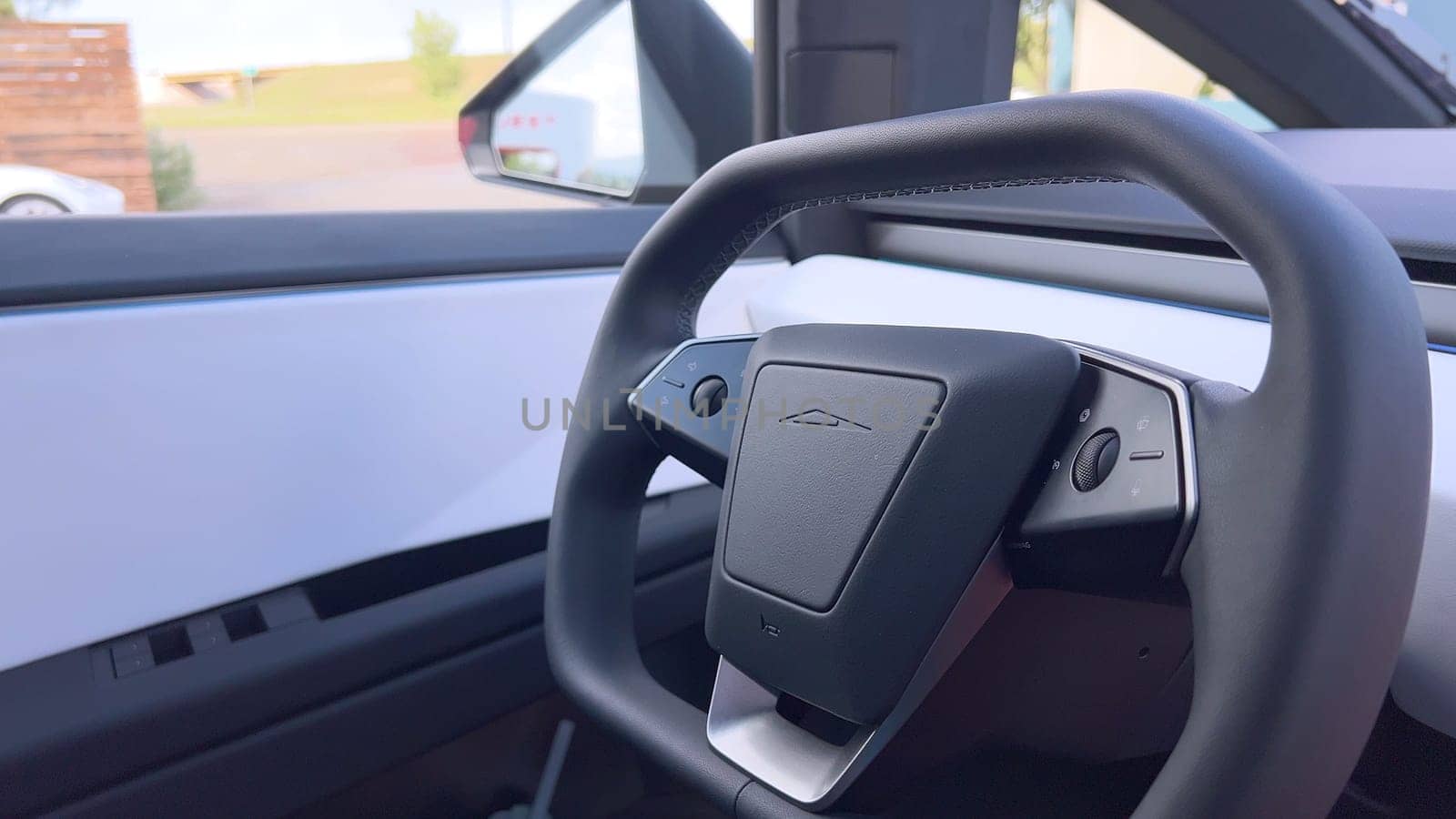 Denver, Colorado, USA-June 11, 2024-Slow motion-The interior of a Tesla car featuring the Dog Mode screen. The display reassures passersby that the driver will be back soon and the air conditioning is set to 69F for the comfort of a pet inside.