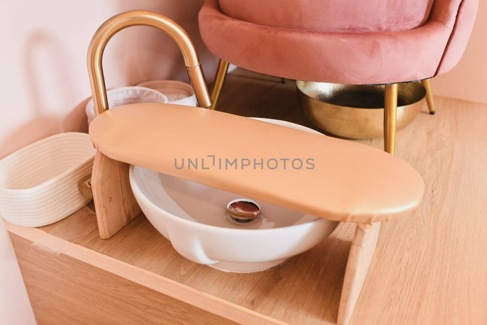 Pink chair and tub for pedicure in a beauty salon