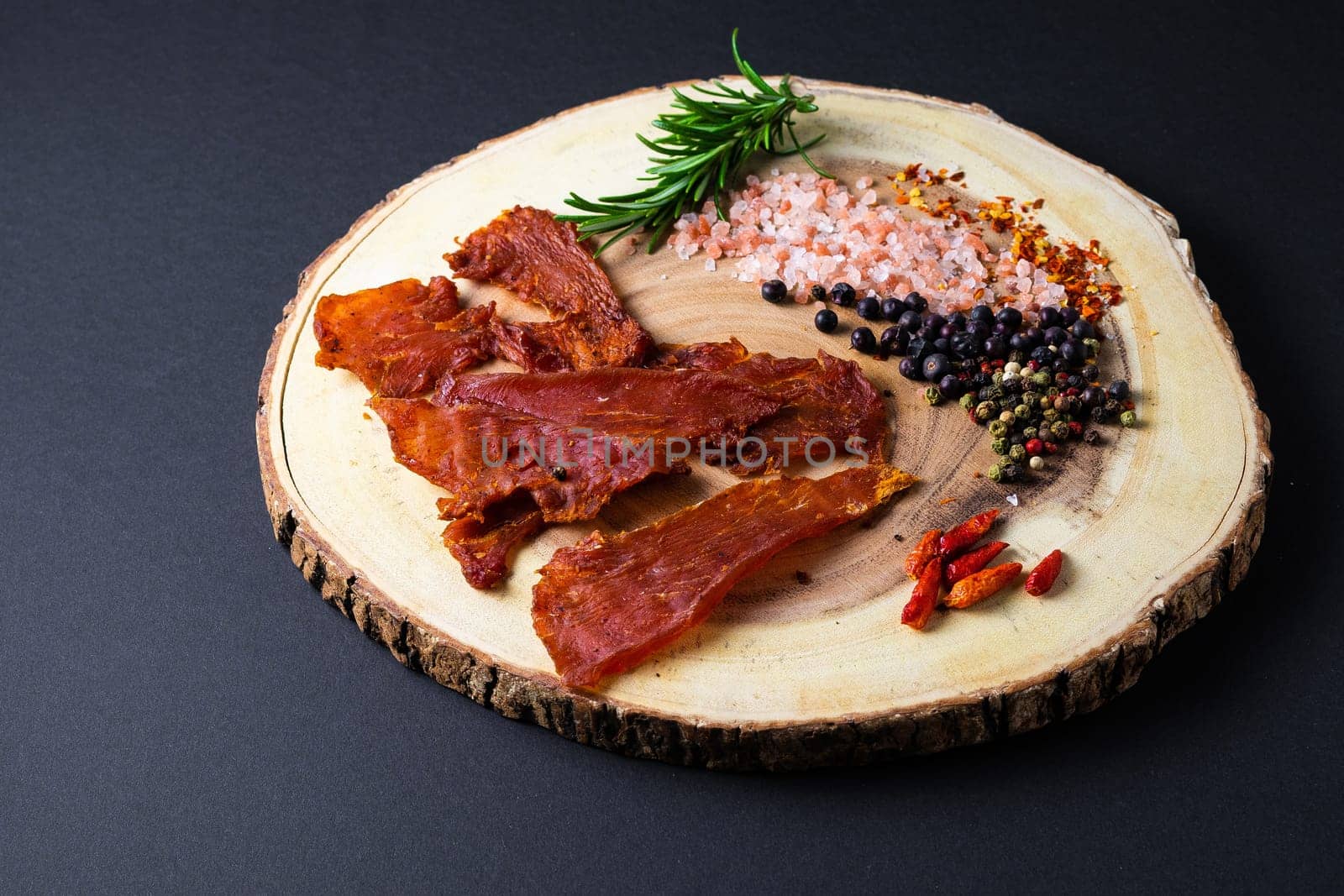 Beef jerky pieces isolated on a white and black background by Zelenin
