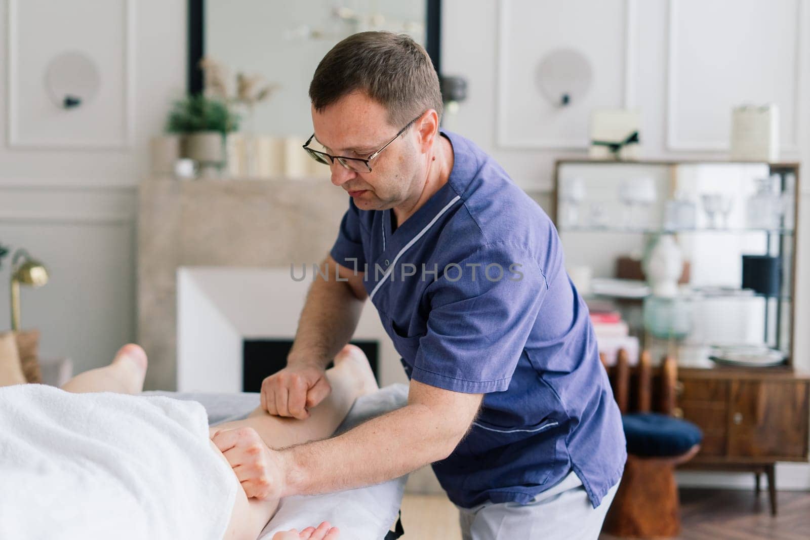 A woman receiving a belly massage at beauty salon