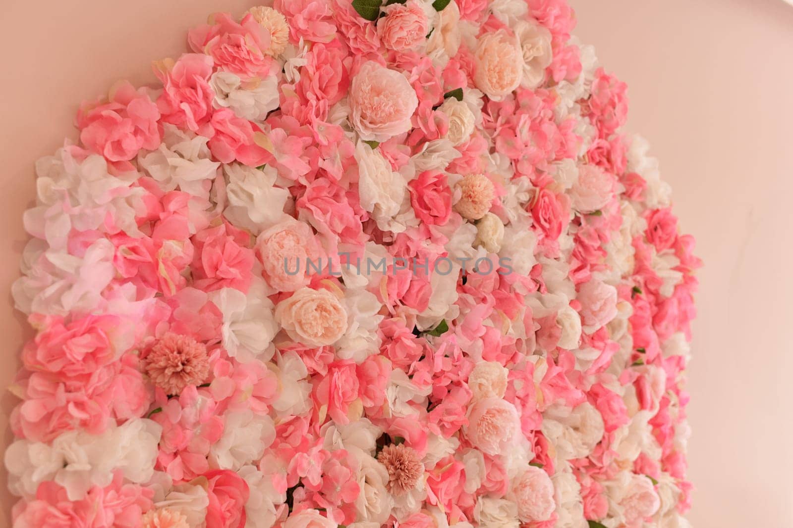 Artificial pink roses on the wall of a beauty salon