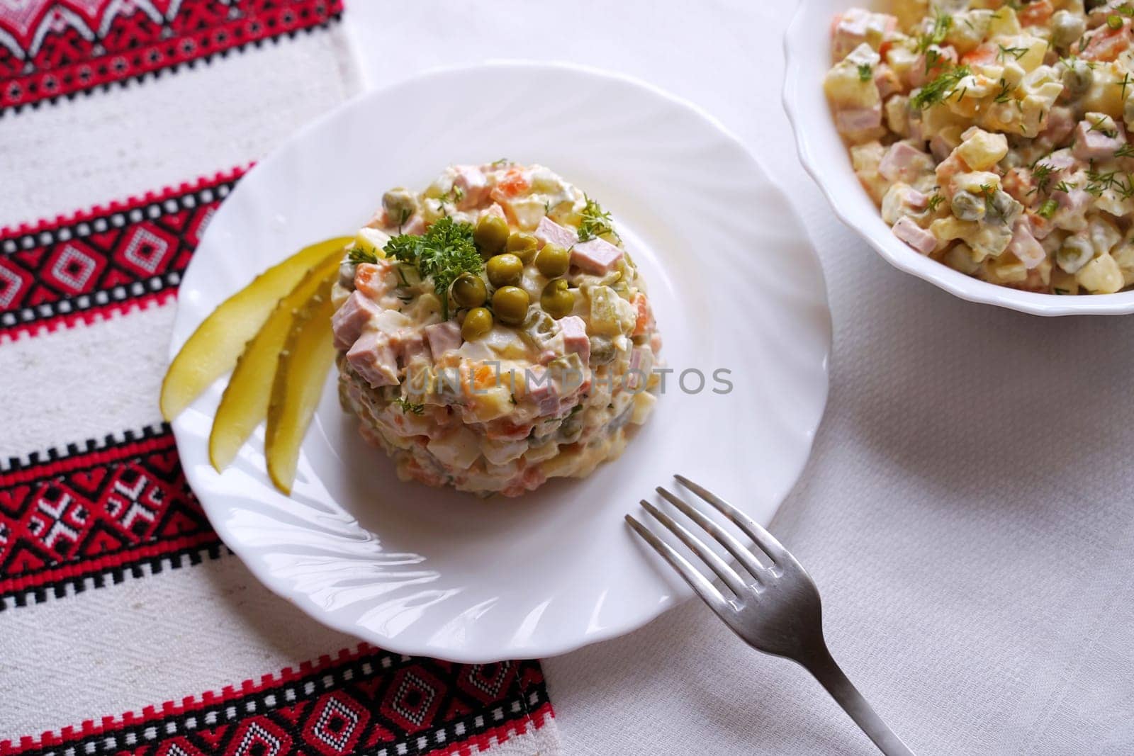 Traditional Ukrainian food on the table with embroidered tablecloth.