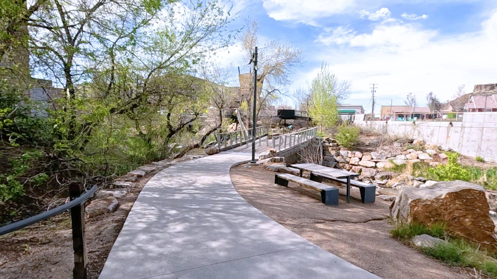 Picturesque View of Downtown Castle Rock, Colorado with Serene River and Modern Buildings by arinahabich