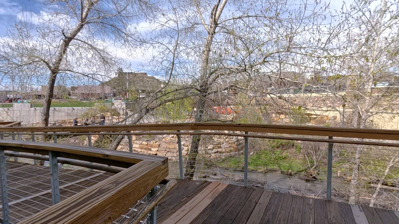 Picturesque View of Downtown Castle Rock, Colorado with Serene River and Modern Buildings by arinahabich