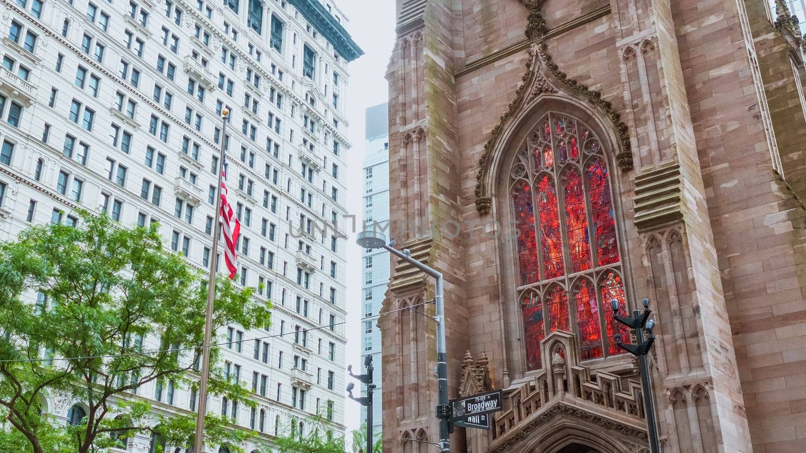 Iconic Trinity Church in Manhattan, New York City, showcases stunning Gothic Revival architecture blending history with modernity in the bustling cityscape, a captivating view.