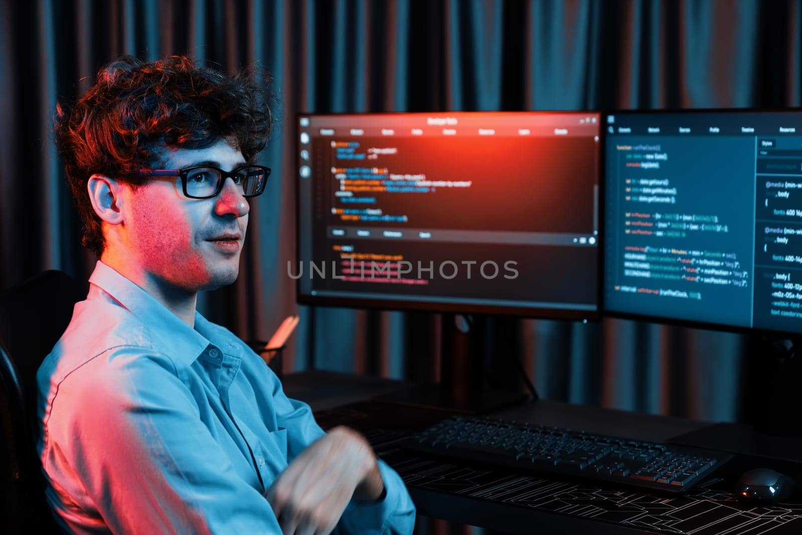 Profile of smiling IT developer sitting against software development information on screen, looking at camera surrounded by creating program coding for latest version application on website. Gusher.