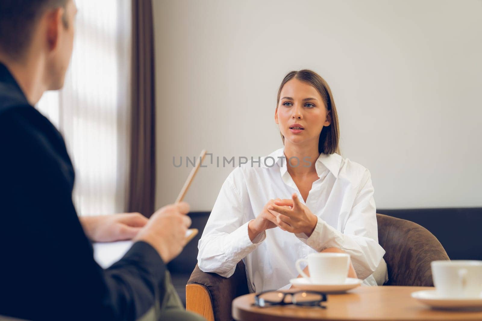 Psychological consultation gaining improvement on mental problem, happy young female patient doing therapy session while psychiatrist making diagnostic on mental illness. Unveiling
