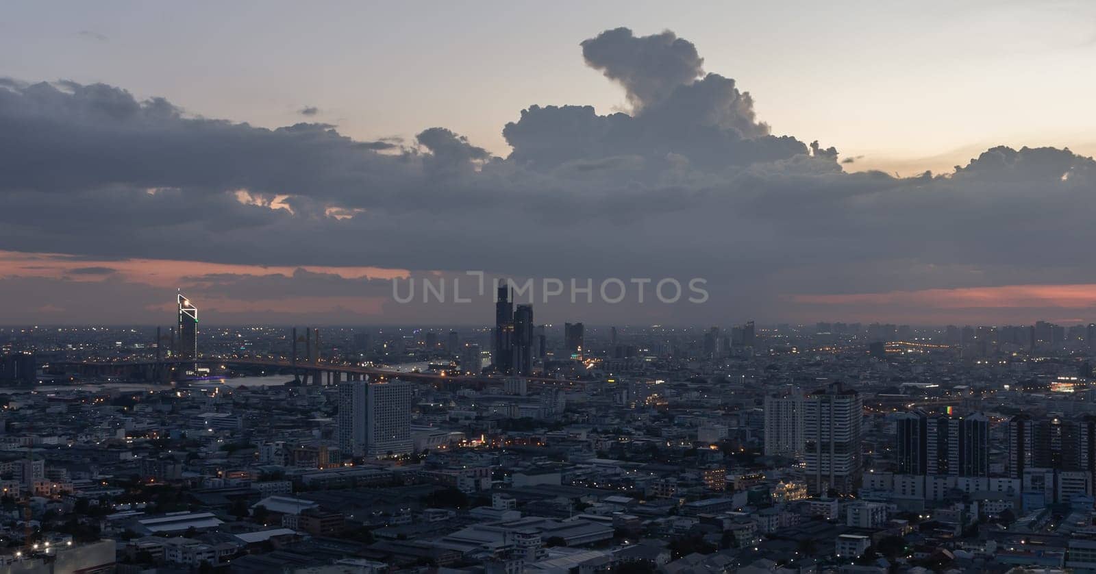 Bangkok, Thailand - 15 Jun, 2024 - Aerial view of skyscrapers and dramatic sky before sunset. Beautiful clouds in the sky over large metropolitan city of bangkok, Space for text, Selective focus.