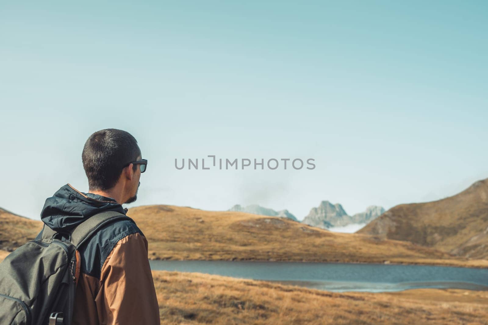 Young traveler with backpack hiking outdoor Travel Lifestyle and Adventure concept. by PaulCarr