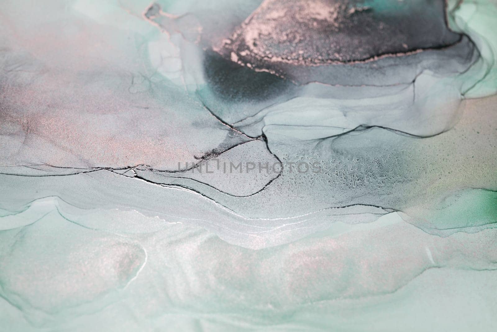 A close-up view of an abstract painting featuring swirling blue and gold hues against a white background. The artwork resembles a sky, water, or other natural element.