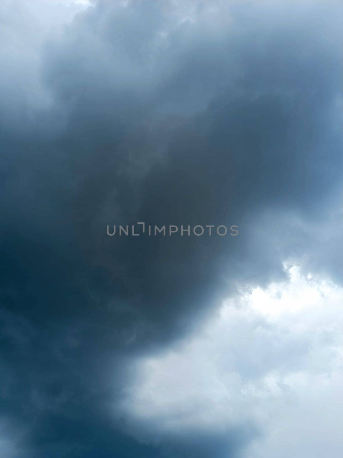 Dramatic sky with storm clouds before rain. Panoramic view of the stormy sky and dark clouds. Concept on the theme of weather, natural disasters, typhoon. High quality photo. Mobile vertical photo