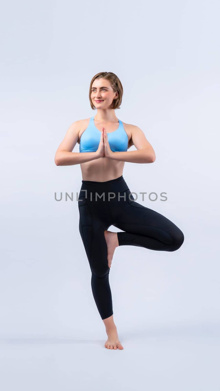 Full body length gaiety shot athletic and sporty woman doing healthy and meditative yoga exercise workout posture on isolated background. Healthy active and body care lifestyle