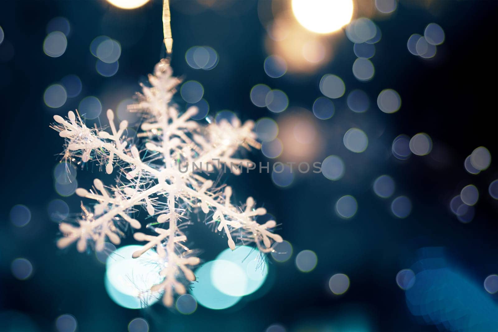 Decorated Christmas tree. Decorated Christmas snowflake on blurred, sparkling and fairy background. Close up.